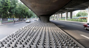 Una serie de conos de cemento dispersos por una superficie impiden que las personas duerman debajo del puente